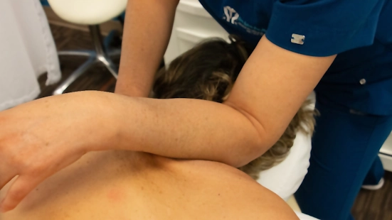 Massage Therapist alleviates shoulder tension